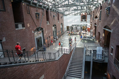 High angle view of people walking on street amidst buildings