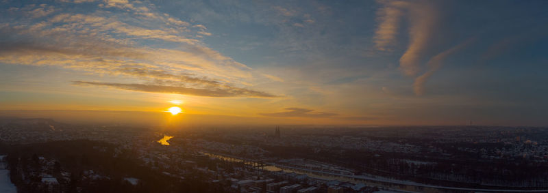 Aerial view of city against sky during sunset