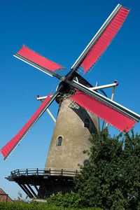 Low angle view of traditional windmill against clear sky