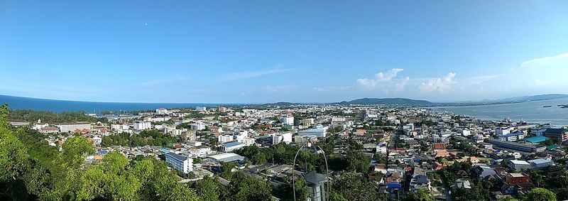 High angle view of town by sea against sky
