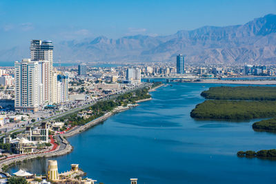 Panoramic view of sea and buildings against sky