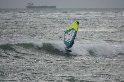 Man with umbrella on sea shore