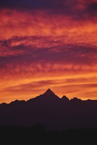 Scenic view of silhouette mountains against sky at sunset