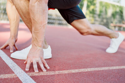 Low section of man and woman running