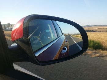 Reflection of car on side-view mirror