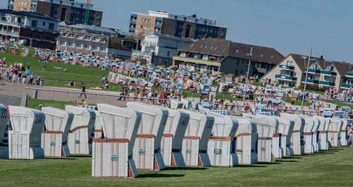 Hooded beach chairs against houses in city