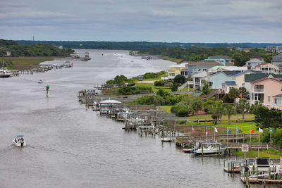 High angle view of buildings by sea against sky