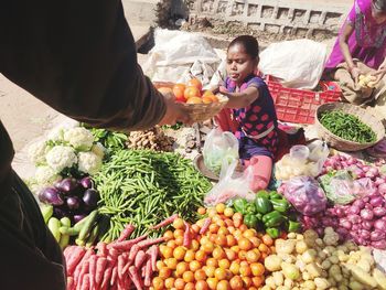 High angle view of friends at market stall