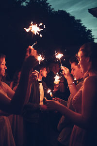 People watching firework display at night