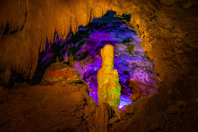Low angle view of multi colored rock formations at night