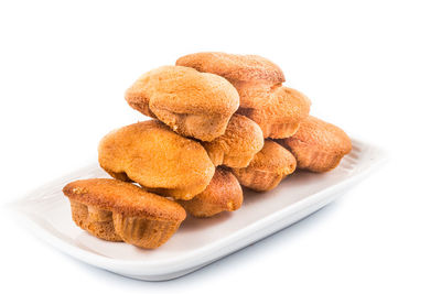 Close-up of cookies in plate against white background