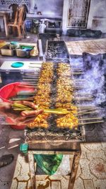 Person preparing food on barbecue grill