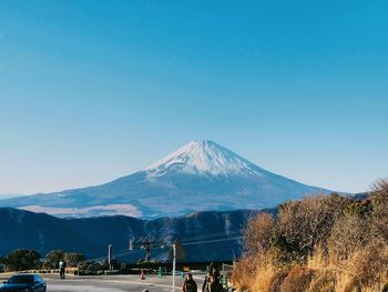 Scenic view of snowcapped mountains against clear blue sky