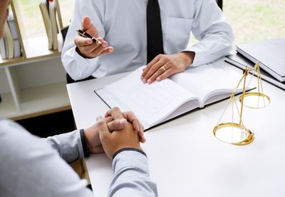 Low section of man wearing mask on table