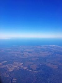 Aerial view of landscape against clear blue sky