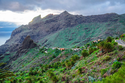 Scenic view of sea and mountains against sky