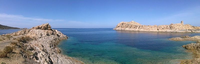 Panoramic view of sea against blue sky