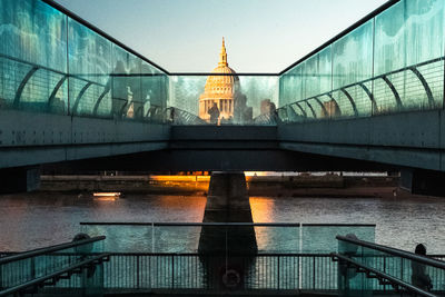 Bridge over river against sky during sunset