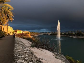 View of bridge over river against cloudy sky