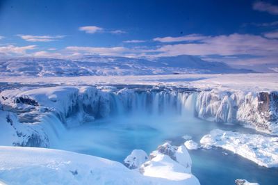 Scenic view of snowcapped landscape against sky godafoss