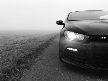 Car on landscape against clear sky