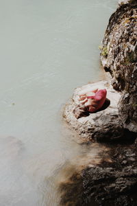 High angle view portrait of girl on rock
