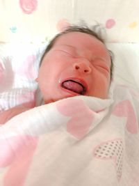 Cute baby girl lying on bed