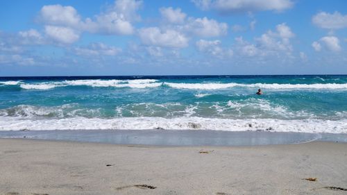 Person in sea against sky