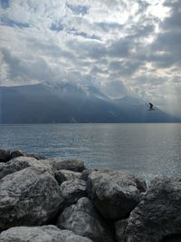 Scenic view of sea and mountains against sky