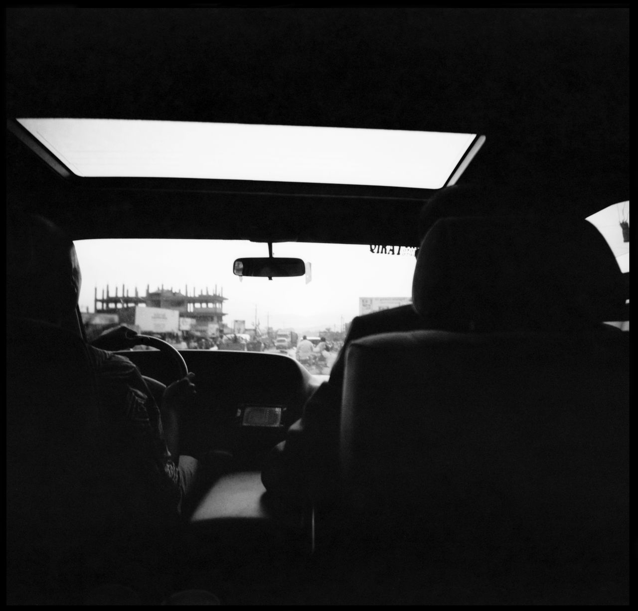 REAR VIEW OF SILHOUETTE MAN TRAVELING IN CAR