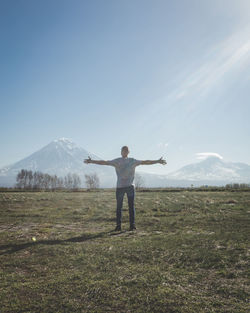 Full length of man standing on field against sky