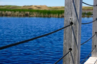 Close-up of railing against sea