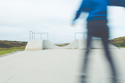 Blurred image of man skateboarding at park