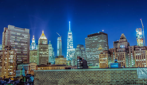 Illuminated cityscape against sky