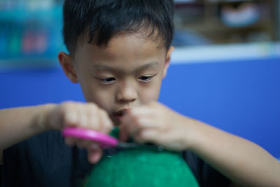 Close-up of cute boy holding scissors