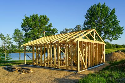 Construction of a simple wooden recreation building on the lake shore