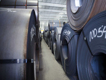 Stack of rolled up metal sheets at distribution warehouse