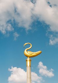 Low angle view of statue against blue sky