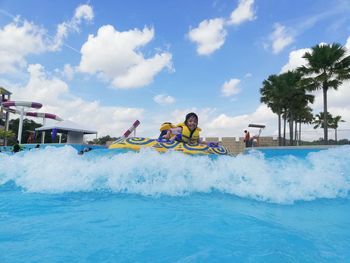 Portrait of girl on inflatable ring in swimming pool