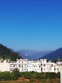 Townscape against clear blue sky