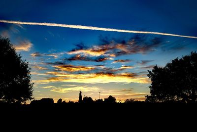 Low angle view of silhouette trees against sky during sunset