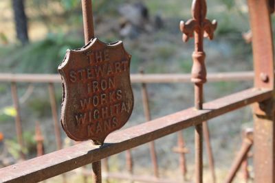Close-up of text hanging on wood