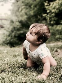 Close-up of cute baby girl on grass