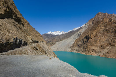 Scenic view of snowcapped mountains and lake against blue sky