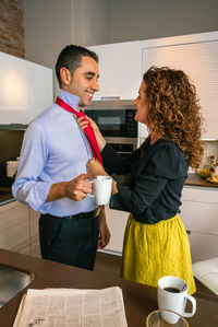 Young couple sitting on table at cafe