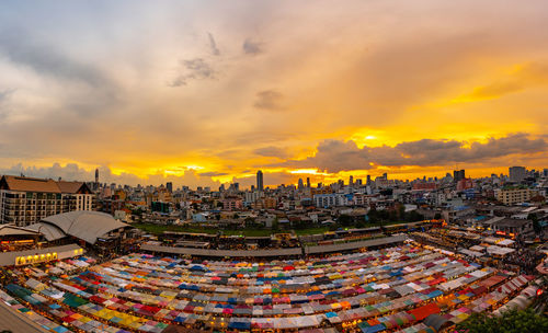 High angle view of city buildings against sky during sunset