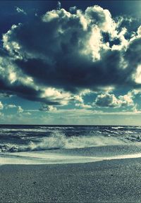 Scenic view of sea against cloudy sky