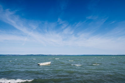 Scenic view of sea against sky with a boat