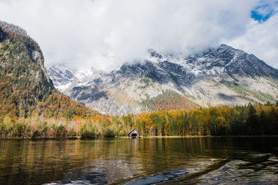 Scenic view of lake königssee in fall with mountains against sky