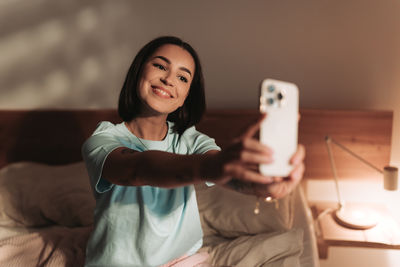 Portrait of young woman using mobile phone